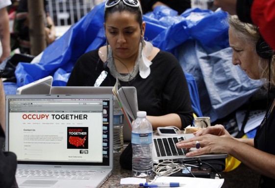 Occupy Wall Street protesters work on laptops in Zuccotti Park in New York